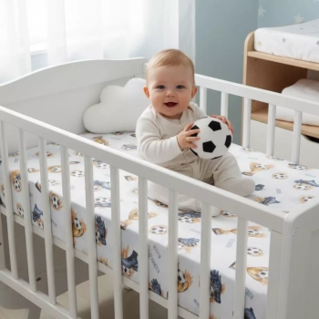 Białe łóżeczko niemowlęce z prześcieradłem w piłki 120x60 – aranżacja pokoju chłopca